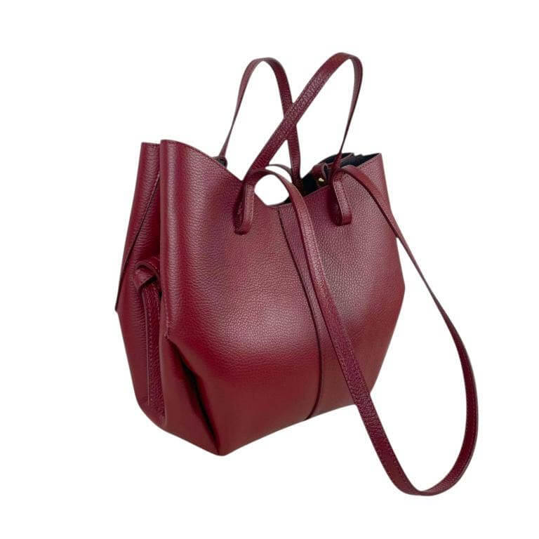 Elegant Italian leather handbag in deep burgundy with convertible design and adjustable straps.